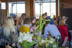 a group of people in a room with flowers