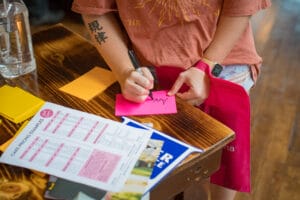 A Women is writing in the piece of paper