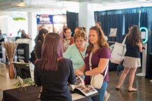 3 women discussing on the project in the event