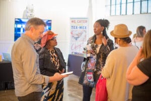 A Group of people discussing something in the event