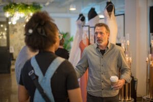 A man talking to a women in the fashion event