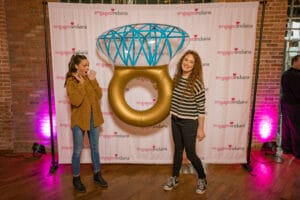 A Women is Talking a photo with a ring shape ballon