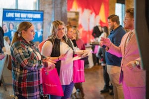 A man talking to couple of womens in the event