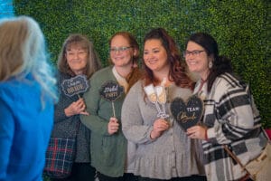 A Group of women taking a photo in with the prompt " team bride "