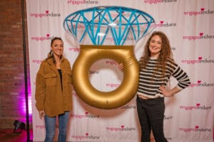 A Women is Talking a photo with a ring shape ballon